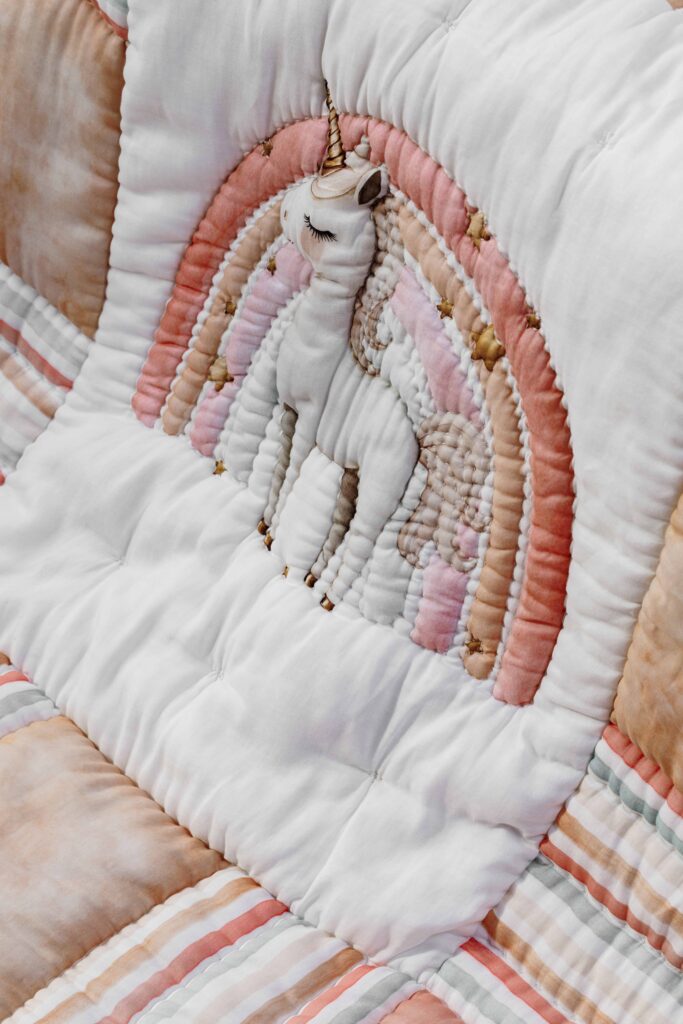 MiRooh Cosmic Candy Collection with pastel unicorn-themed bedding and embroidered cushions for children's bedrooms.