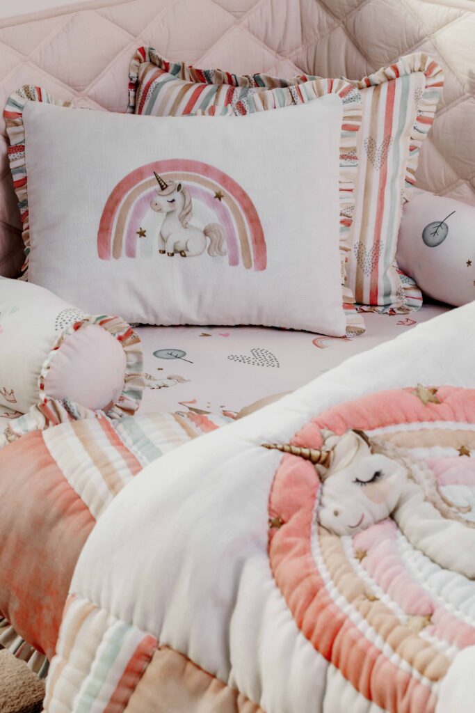 MiRooh Cosmic Candy Collection with pastel unicorn-themed bedding and embroidered cushions for children's bedrooms.