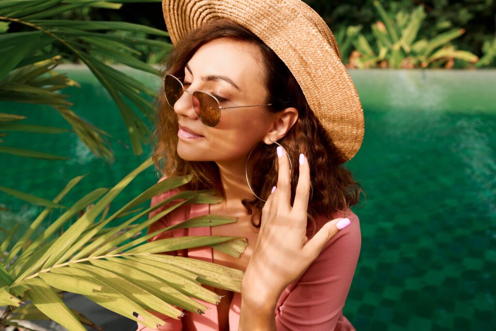 Meltdown Proof: How to Protect Your Skin from India’s Ultimate Summer 122 close up portrait pretty woman with curly hairs straw hat posing near pool